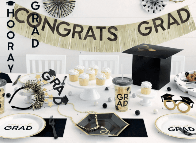 Black and gold graduation party table setup