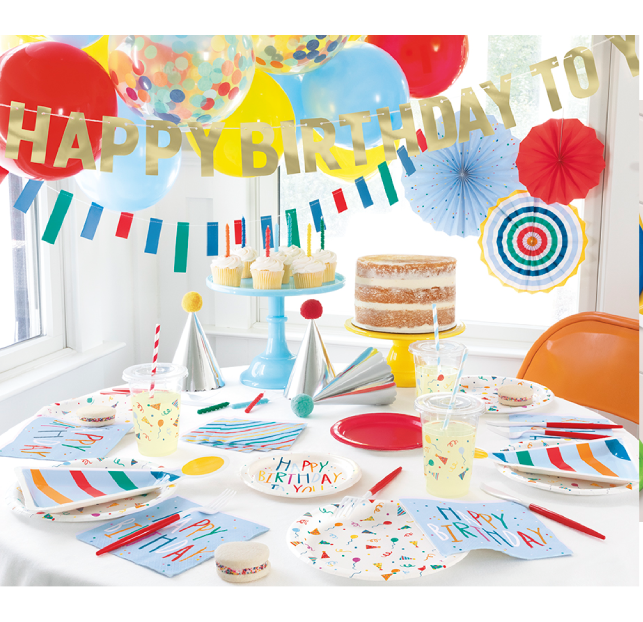 Colorful birthday party setup with decorations and cake.