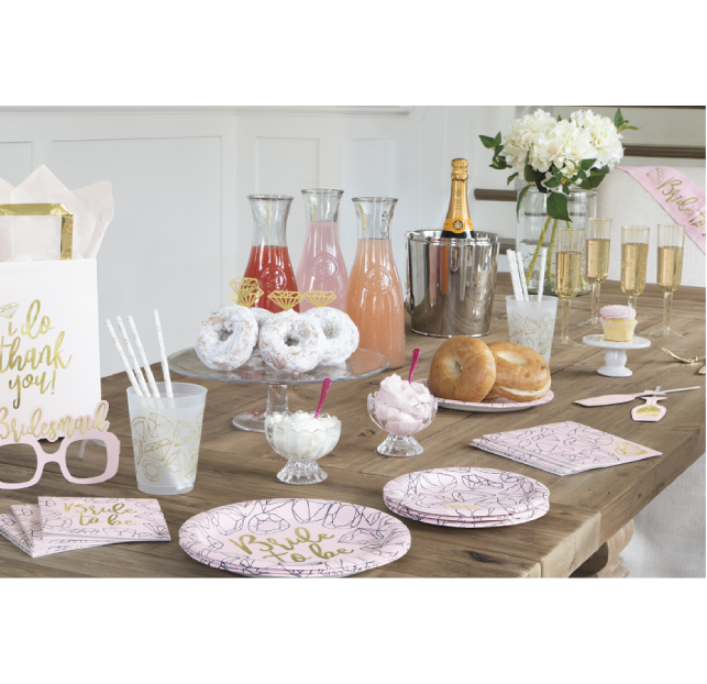 Elegant dessert table with cakes, pastries, and floral decorations.
