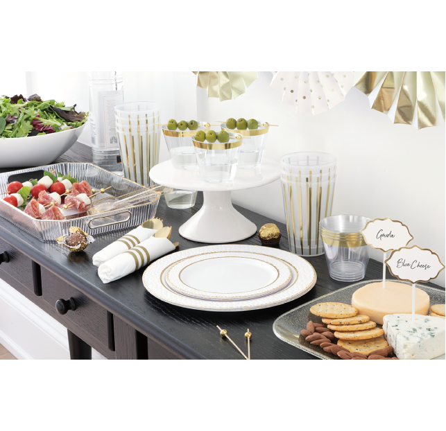 Elegant party table with appetizers, drinks, and festive decorations.